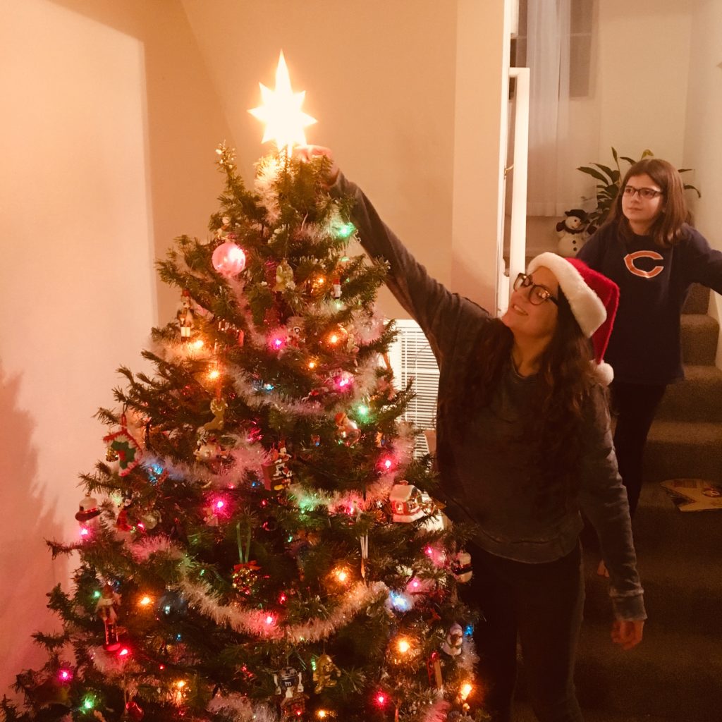 My Gem putting the star on top of the Christmas Tree, while my Jewel watches her sisters turn this year!